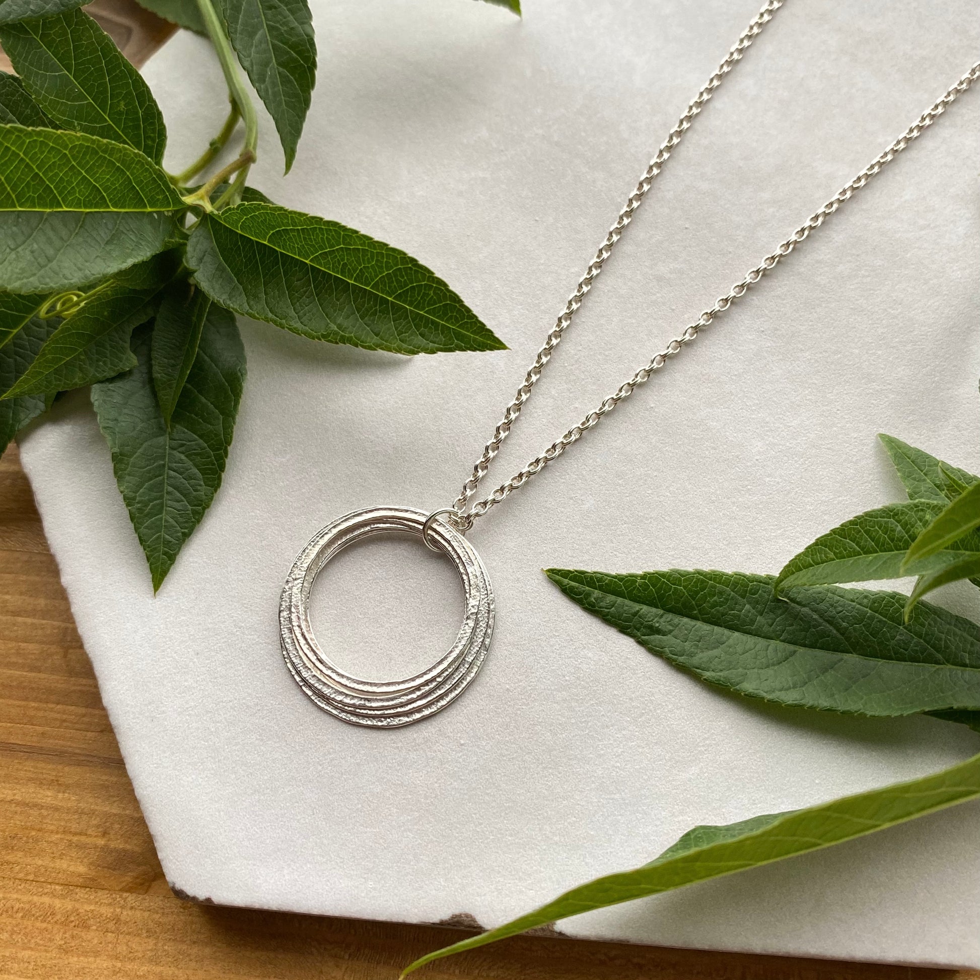 6 rings for 6 decades silver pendant 